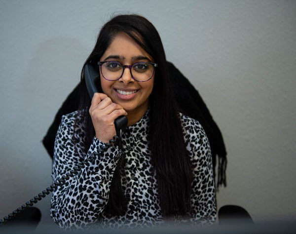 person on phone while smiling