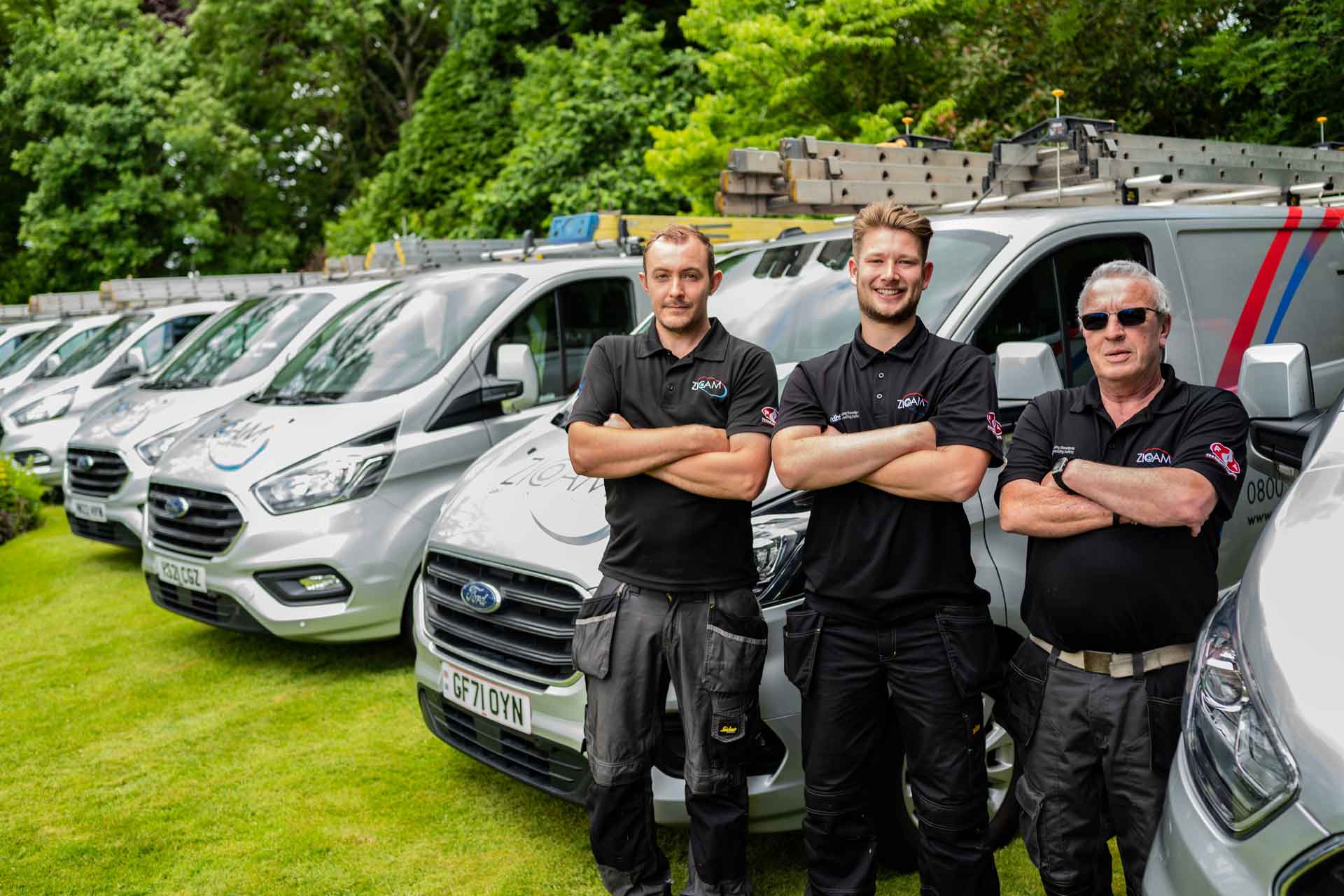 An image of the Zicam Security Gates Team in front of vans