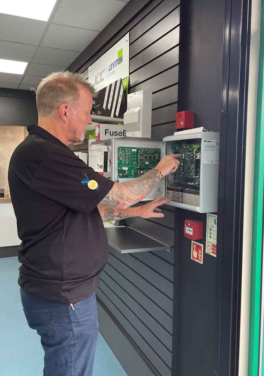 An image of a Zicam engineer servicing a fire alarm