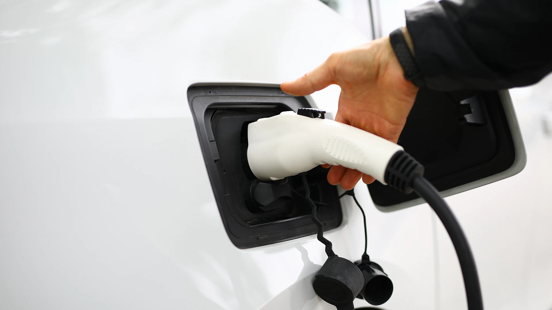 Image of a commercial EV charger plug inside an electric vehicle.